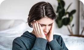 Woman holding her face in both hands